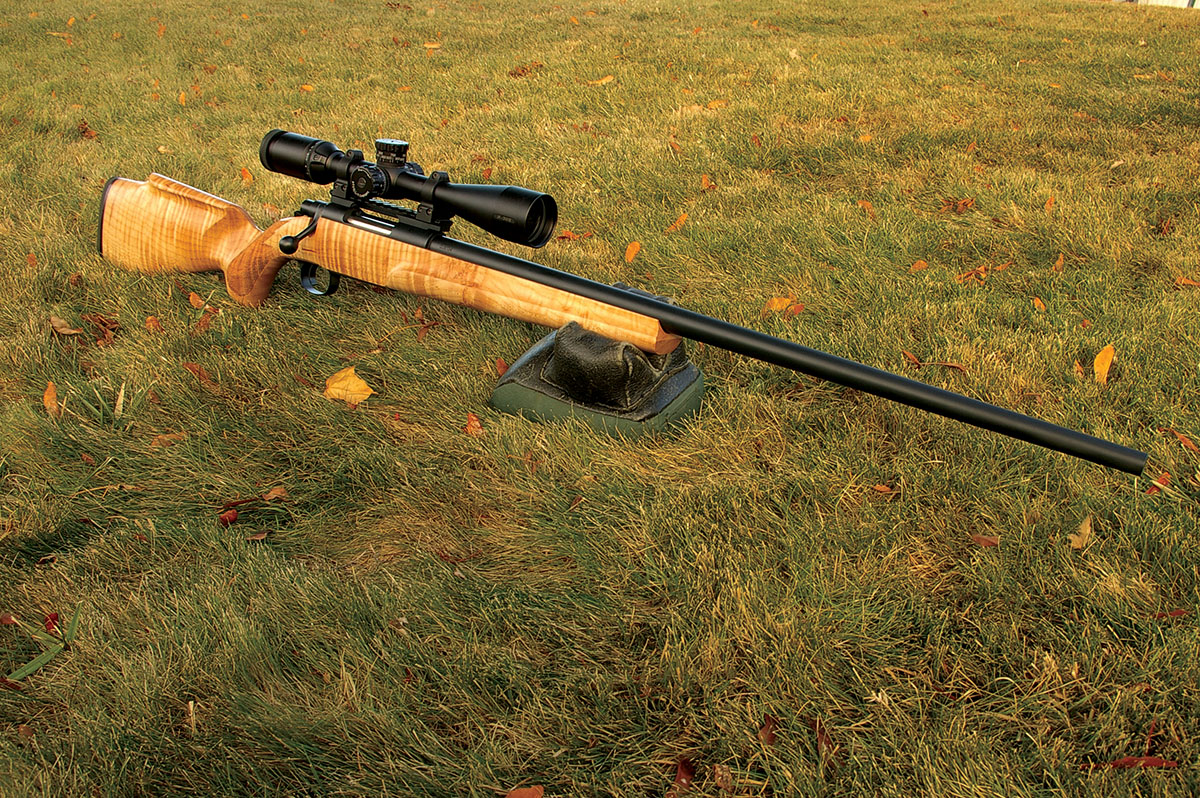 The Cooper Custom Model 54 22-250 Remington features a stock of figured maple.