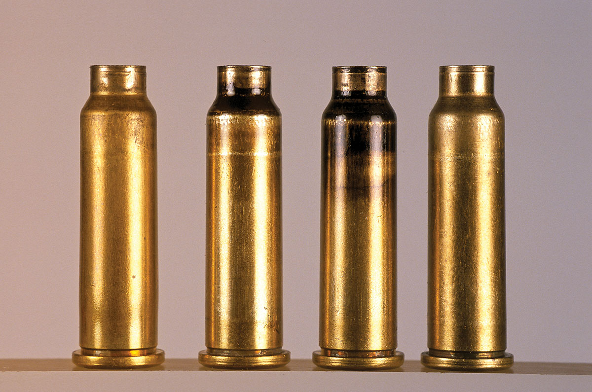 Using the method of neck sizing only, cases include (left to right) a newly fired case, a case smoked with a candle, a neck sized case and a finished version.