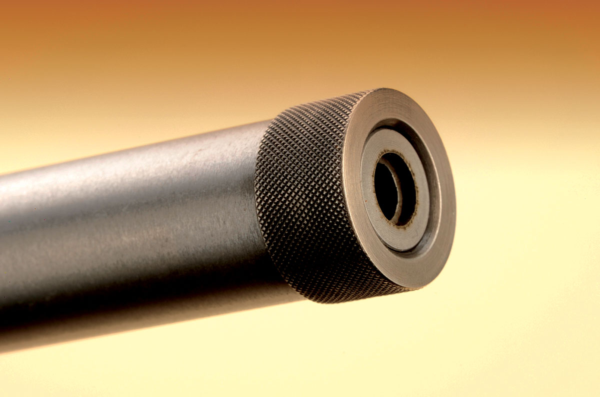The muzzle on the barrel was threaded for a suppressor. A protective cap keeps the threads fresh and clean.