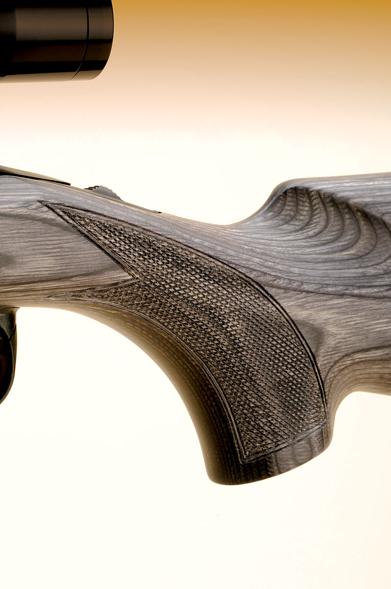 The grip has a slight swell to it on both sides and is checkered in a point pattern. No grip cap is provided to keep this part of the stock from chipping in the field.