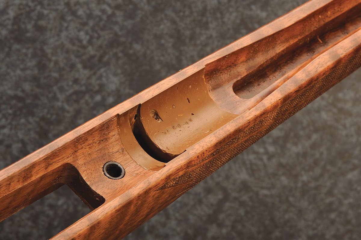 Bedding compound is applied to the stock around the recoil lug.