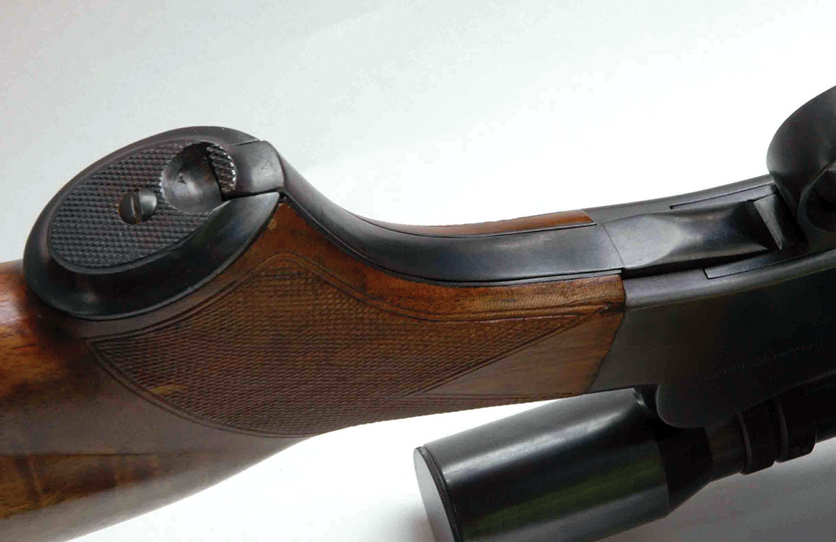 The underlever rests in a steel liner inletted into the grip of the stock with a flush fit. A steel cap attached to the bottom of the grip was relieved for a checkered grasping tab on the end of the lever.