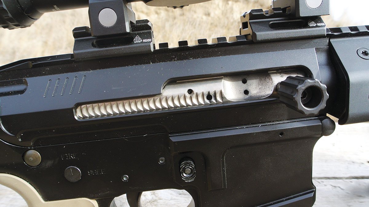 The MT-15’s side-charging bolt in battery on the range. The system allowed for easy bolt manipulation during range testing. The bolt handle is threaded in the bolt carrier group and must be removed using a hex key before the rifle can be fieldstripped for cleaning.
