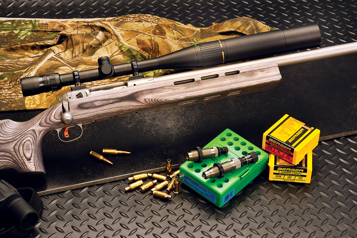The Savage Model 12 Benchrest rifle was equipped with a Bushnell 6-24x 40mm scope and extended lens hood. It has a laminated stock, 29-inch barrel and a target trigger as standard equipment. Note the long forearm with vents for barrel cooling.
