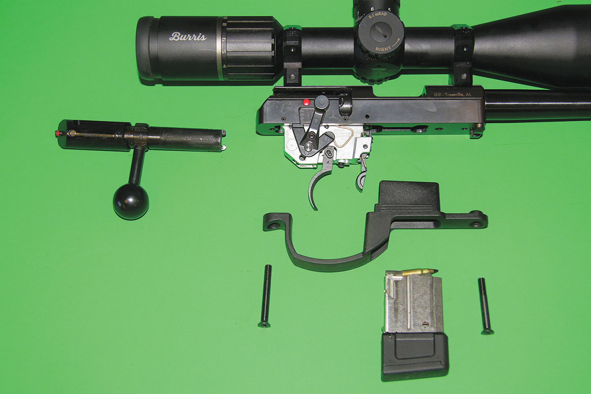 This photo shows the Anschütz Model 1761 HB 20-inch 17HMR Thumbhole Single Stage Light Trigger taken down to its essential parts. The action is new, including an integral recoil lug.