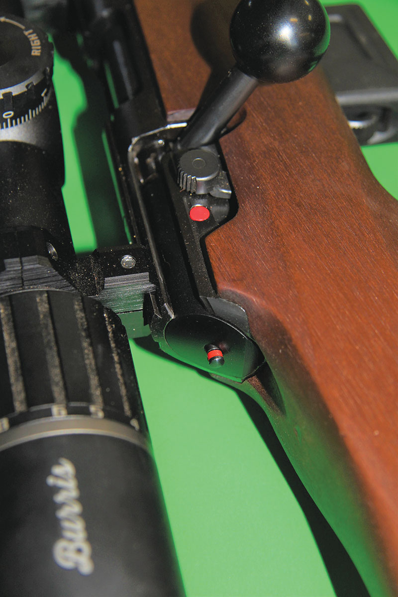 The safety is pulled back for “safe,” pushed forward to “fire.” Engaging the safety disengages the sear. The rifle can also be unloaded while on “safe.”