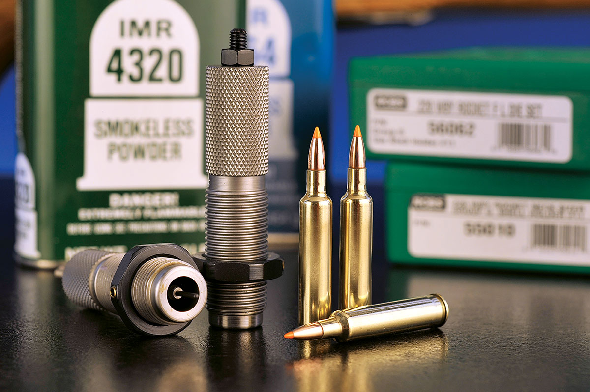 Three 220 Rocket rounds and the front of the die with some of the components in the background. The dies are from RCBS.
